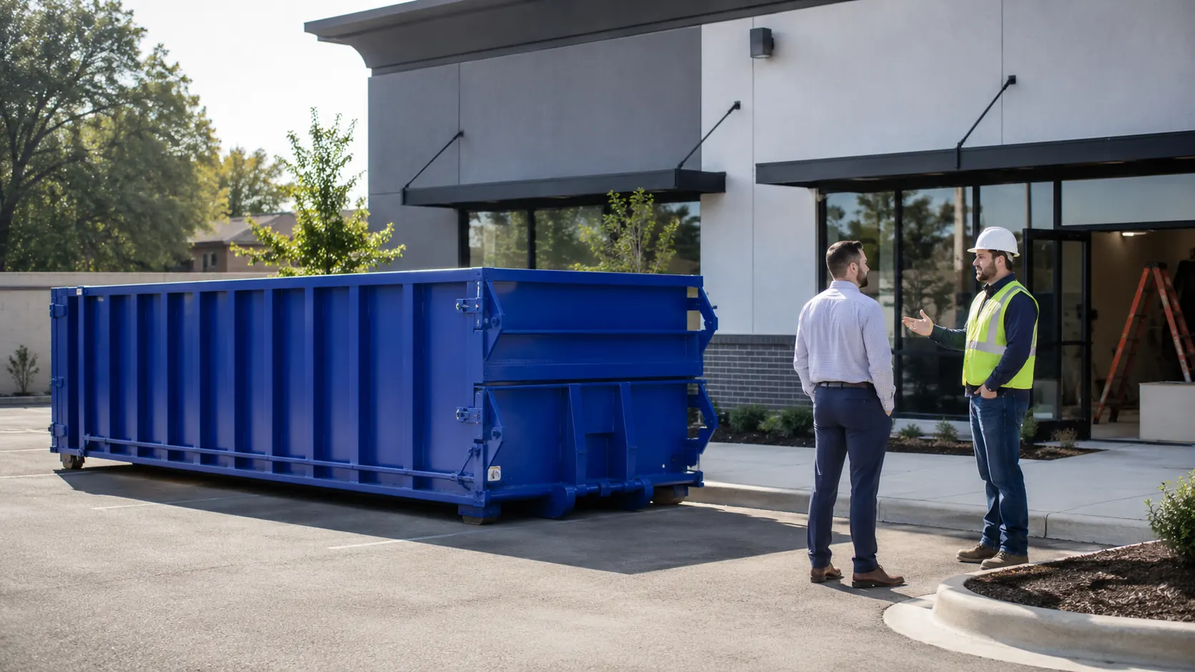 Commercial roll-off dumpster beside a business property